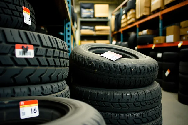 Stacked winter tires with numbered tags on a tire shop storage rack. How Toronto tire shops price and insure winter tire storage